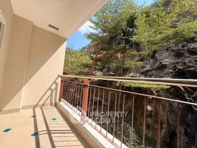 Spacious balcony with stunning natural rock view and lush greenery, perfect for relaxation and outdoor enjoyment.