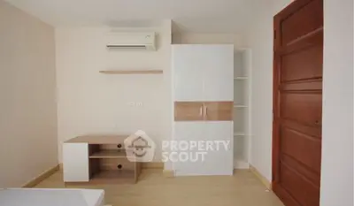 Minimalist bedroom with wooden furniture and air conditioning