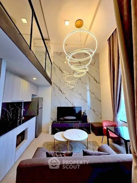 Luxurious modern living room with high ceilings and elegant lighting in a stylish apartment.