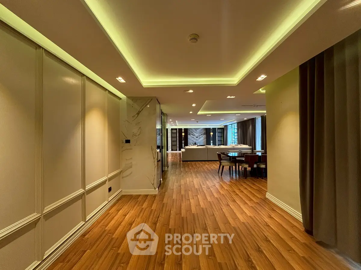 Spacious modern living room with elegant wooden flooring and ambient lighting