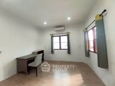 Spacious study room with natural light and modern furnishings