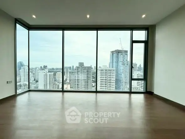 Spacious corner unit with stunning city skyline view through floor-to-ceiling windows.
