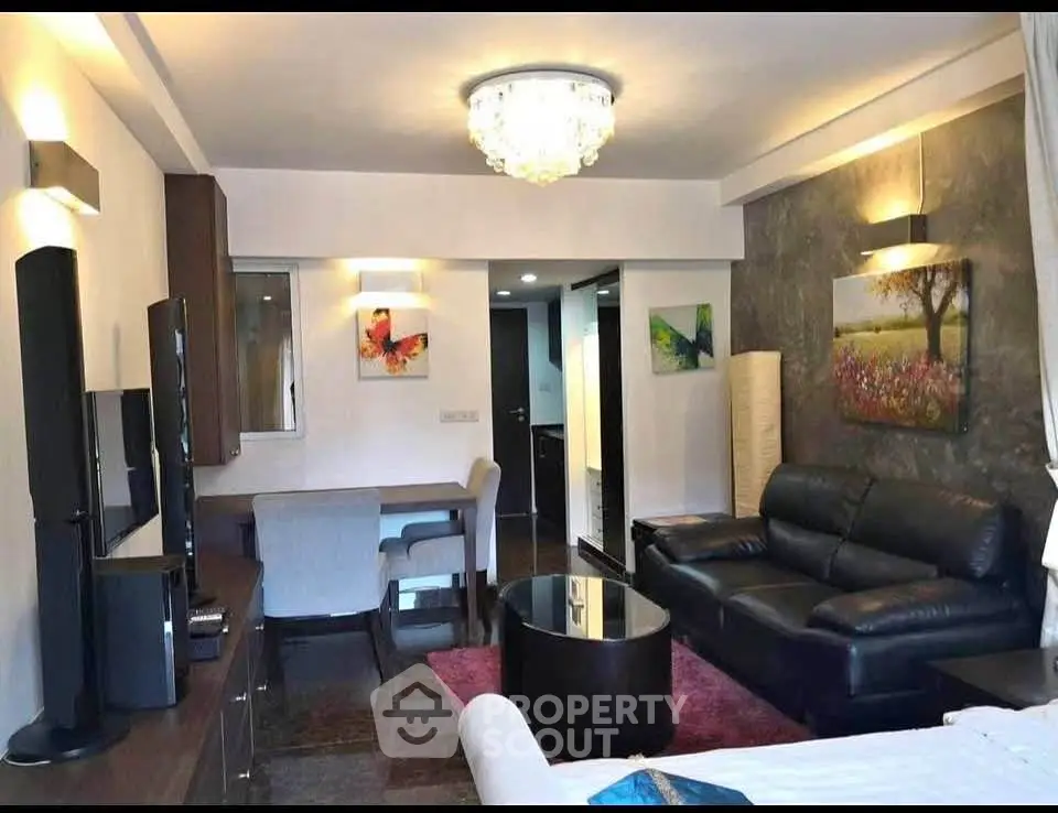Stylish living room with modern decor and elegant lighting in a cozy apartment.
