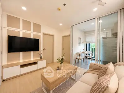 Modern living room with stylish decor and open layout leading to dining area and balcony.