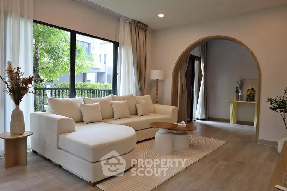 Elegant living room with modern decor and large windows