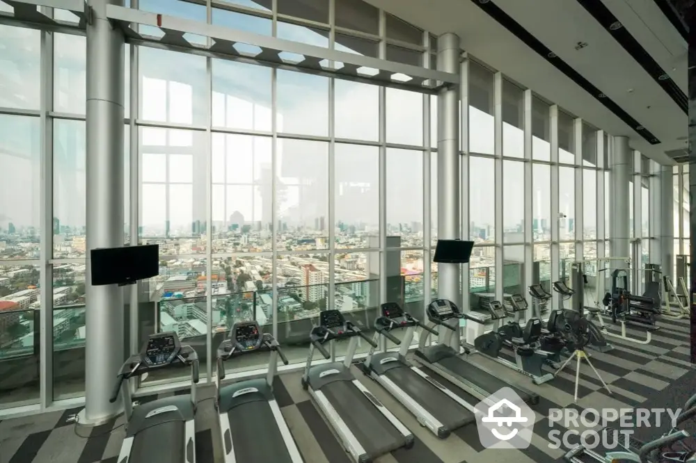 Luxurious high-rise gym with panoramic city views and modern fitness equipment.