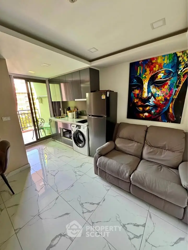Modern living room with sleek kitchen and vibrant artwork, featuring marble floors and balcony access.