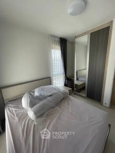 Cozy bedroom with modern design and large mirrored wardrobe