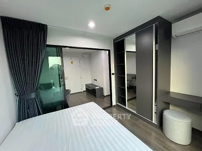 Modern bedroom with sleek wardrobe and stylish decor in a contemporary apartment.