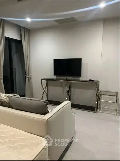 Modern living room with sleek furniture and wall-mounted TV