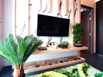 Modern living room with stylish TV setup and lush indoor plants