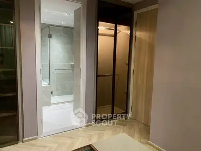 Modern bathroom with glass shower and sleek wooden accents