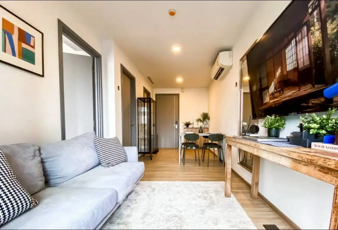 Modern living room with cozy sofa and stylish decor, perfect for relaxation and entertainment.