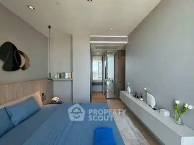 Luxurious modern bedroom with elegant decor and city view, featuring sleek furniture and stylish accents.