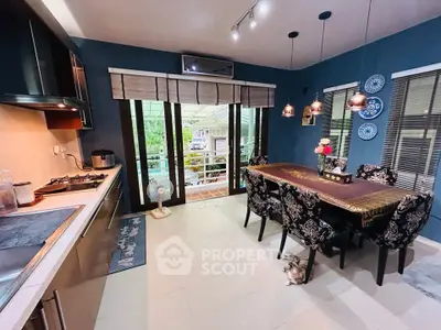 Charming kitchen with open layout and elegant dining area, featuring modern appliances and stylish decor.