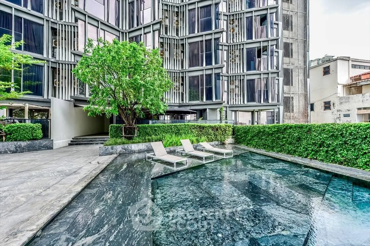 Luxurious modern building with stylish pool and lush greenery