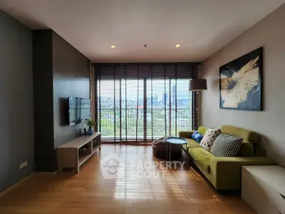 Stylish living room with city view, modern decor, and natural light