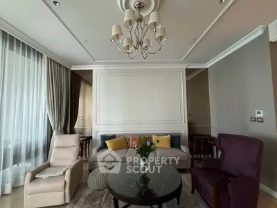 Elegant living room with plush seating and chandelier, perfect for relaxation and entertaining.
