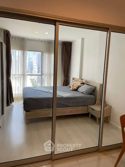 Modern bedroom with glass sliding doors and city view