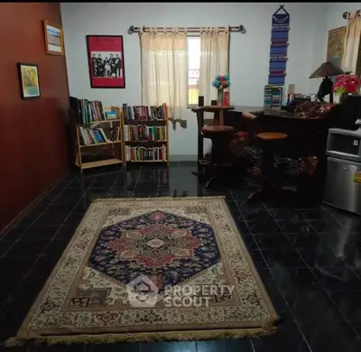 Charming study room with cozy carpet and bookshelves, perfect for reading and relaxation.