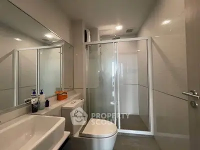 Modern bathroom with glass shower and sleek fixtures