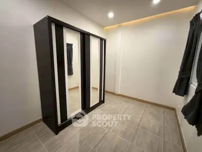 Spacious bedroom with modern wardrobe and elegant lighting