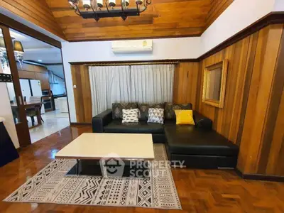 Charming living room with wooden paneling and modern furniture in cozy home