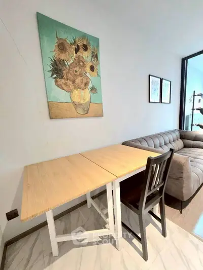 Stylish living room with modern sofa and sunflower painting, perfect for cozy gatherings.