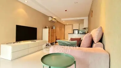 Spacious living room with modern decor and open layout in a stylish apartment.