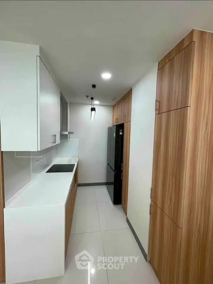 Modern kitchen with sleek cabinetry and high-end appliances in a contemporary apartment.