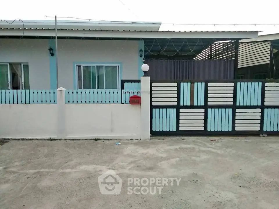 Charming single-story home with modern fence and spacious driveway.