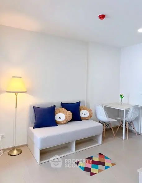 Modern living room with cozy sofa, stylish decor, and dining area in a bright apartment.