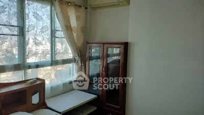 Cozy bedroom corner with window view and wooden furniture