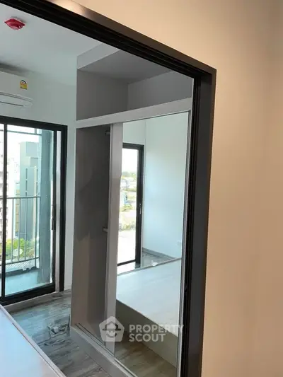 Modern apartment interior with balcony view and sleek design