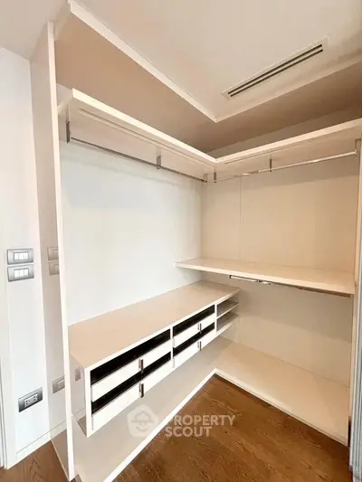 Spacious walk-in closet with modern shelving and ample storage space.