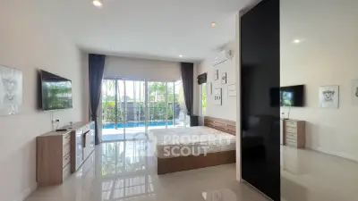 Spacious bedroom with pool view and modern decor in luxury home