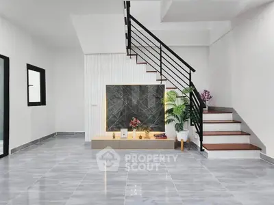 Modern minimalist living room with sleek staircase and stylish decor