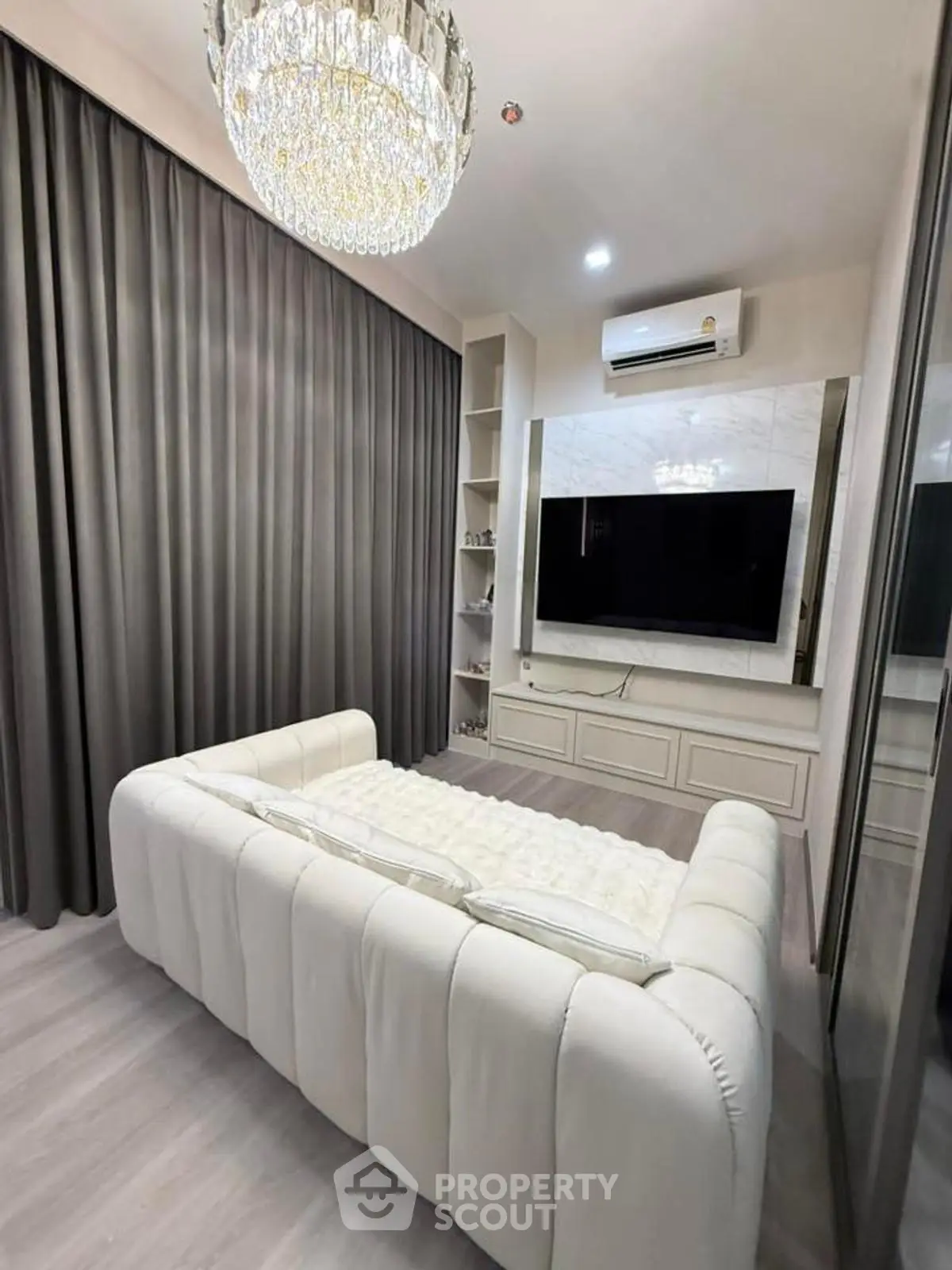 Luxurious bedroom with elegant chandelier and modern decor