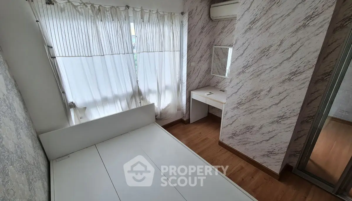 Cozy bedroom with elegant marble wallpaper and natural light