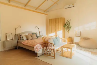 Cozy bedroom with natural light, wooden furniture, and modern decor