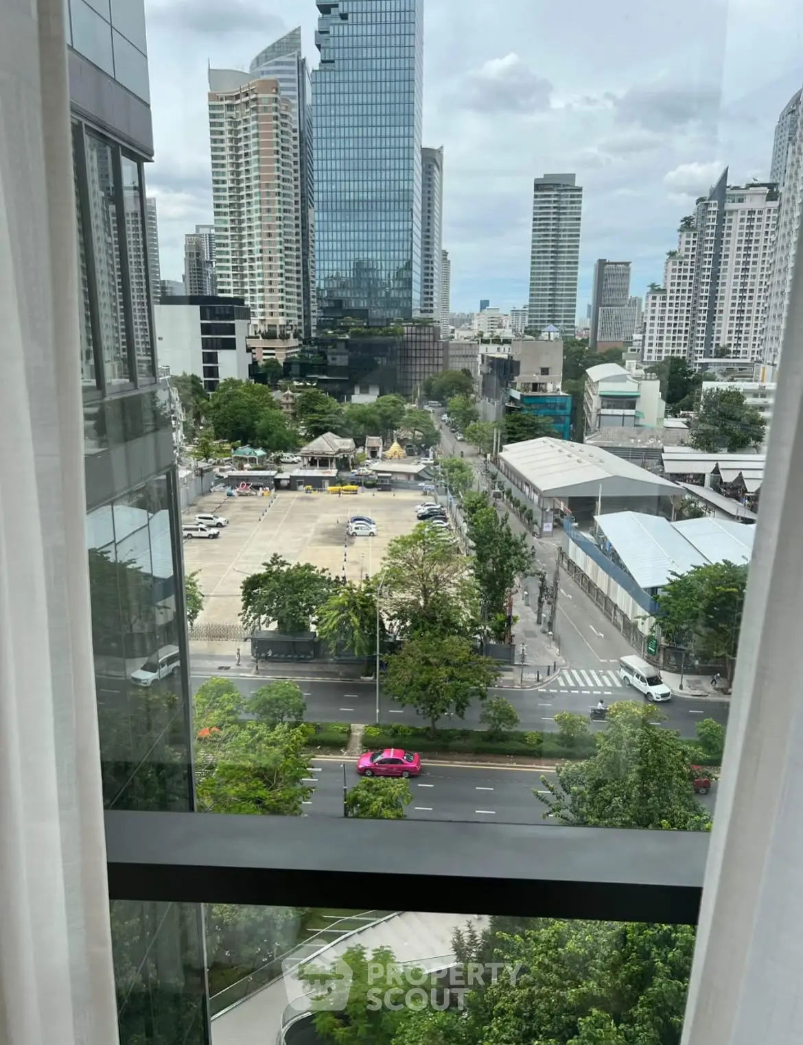 Stunning cityscape view from high-rise window showcasing urban skyline and vibrant streets.