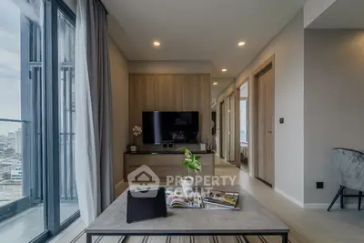 Modern living room with city view, sleek furniture, and natural light.