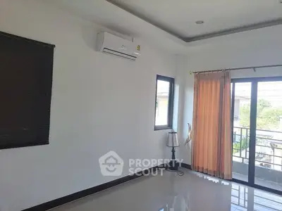 Spacious room with air conditioning and balcony access, perfect for modern living.
