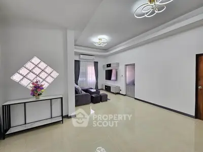 Spacious modern living room with elegant lighting and stylish decor