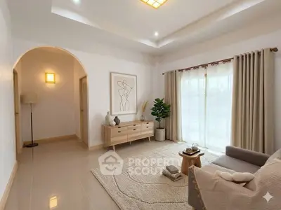 Elegant living room with modern decor, large window, and cozy seating area.
