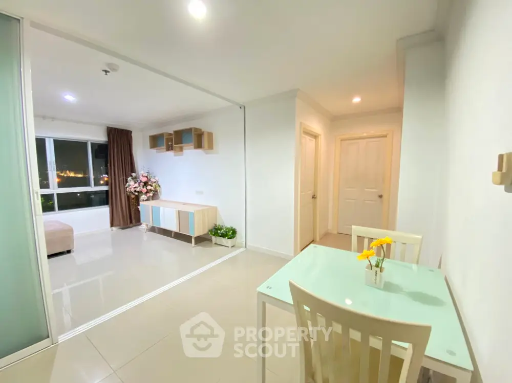 Spacious and well-lit studio apartment with seamless living and sleeping areas, modern furnishings, and a city view from the balcony.