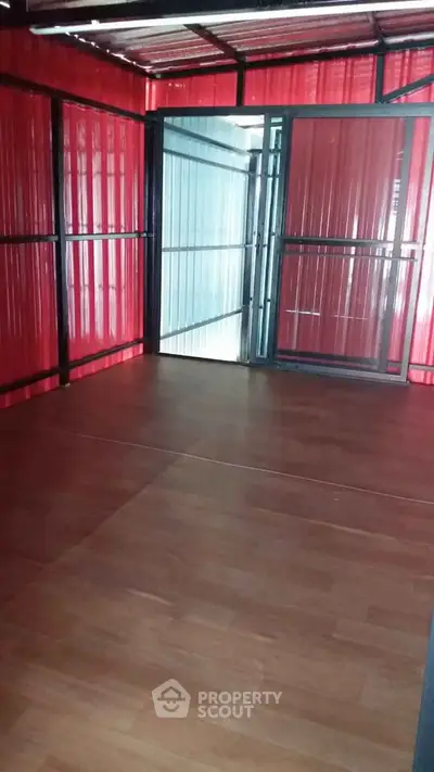 Spacious interior with wooden flooring and sliding glass doors in a modern unit.