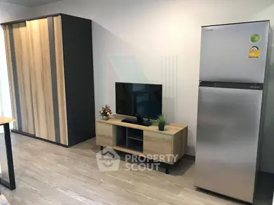 Modern living room with sleek fridge and stylish wooden furniture