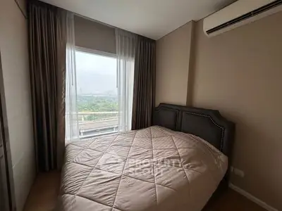 Cozy bedroom with large window and scenic view, featuring a stylish bed and modern air conditioning.