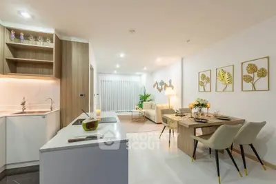 Modern open-plan kitchen and living room with stylish decor and dining area